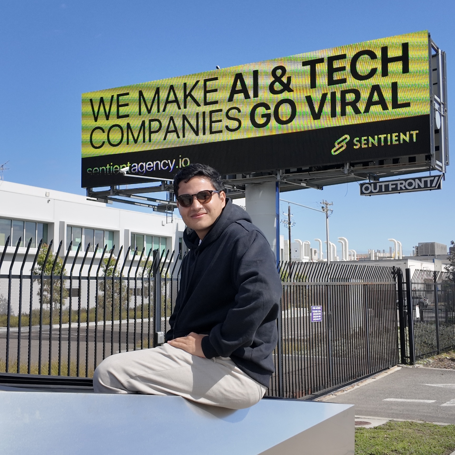 Ivan Acuña in front of the Sentient billboard